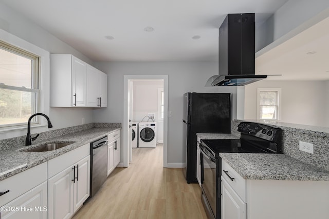 kitchen featuring black electric range, a sink, washing machine and dryer, island range hood, and dishwashing machine