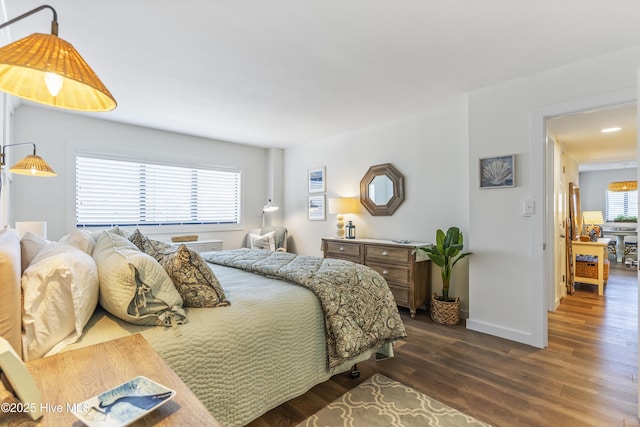 bedroom featuring dark wood-style floors and baseboards