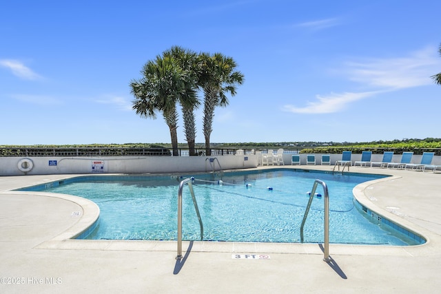 pool featuring a patio and fence