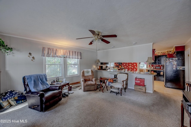 living room with a ceiling fan, light colored carpet, crown molding, and a textured ceiling