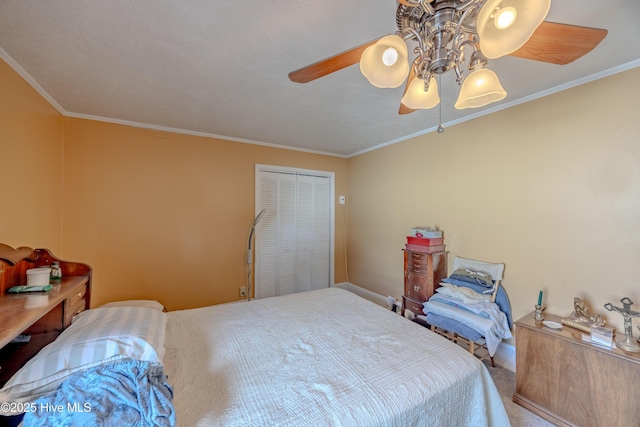 carpeted bedroom with a closet, ceiling fan, and ornamental molding