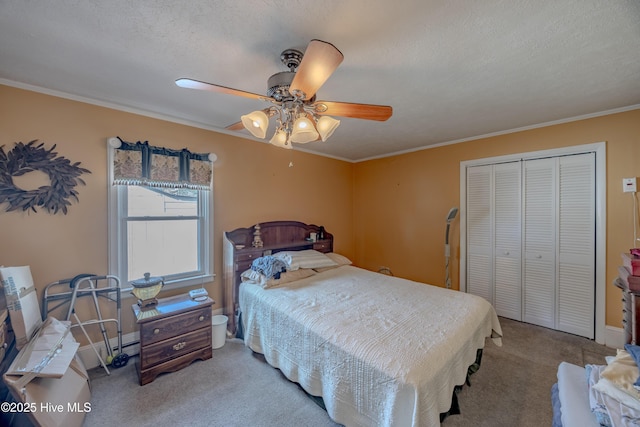 bedroom with a closet, a ceiling fan, crown molding, and carpet