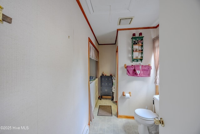 bathroom featuring toilet, visible vents, baseboards, and ornamental molding