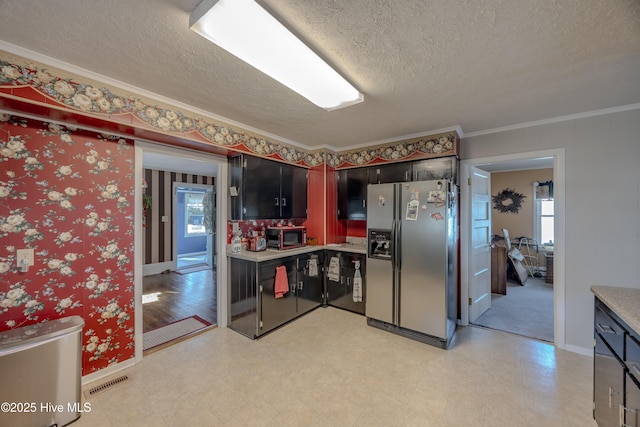 kitchen featuring visible vents, stainless steel fridge with ice dispenser, light floors, light countertops, and a textured ceiling