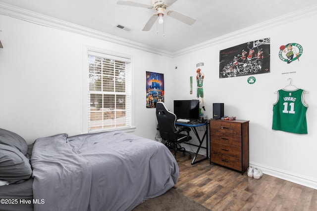 bedroom with visible vents, ornamental molding, a ceiling fan, wood finished floors, and baseboards