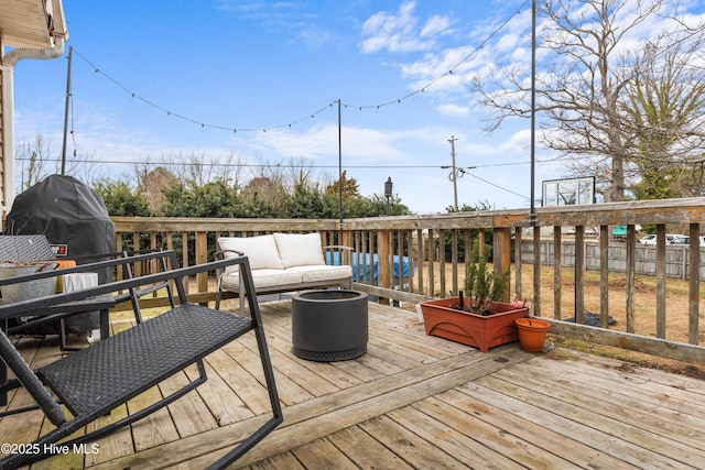 deck featuring an outdoor living space and fence