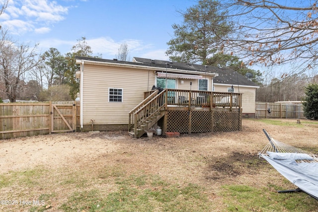 rear view of property featuring fence, stairway, a wooden deck, crawl space, and a gate