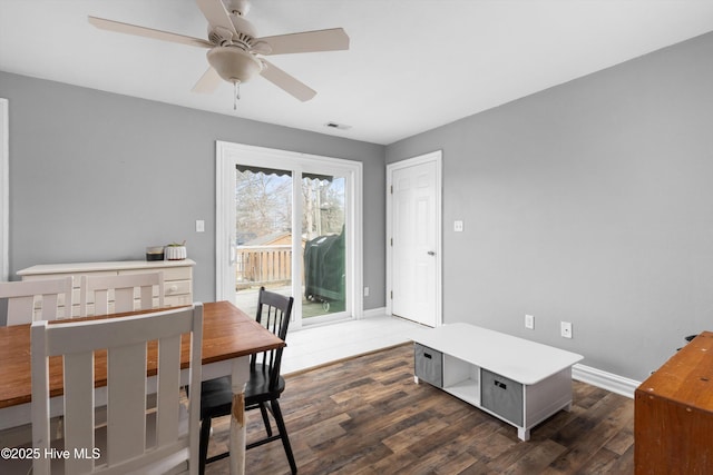 dining area with dark wood finished floors, baseboards, and ceiling fan