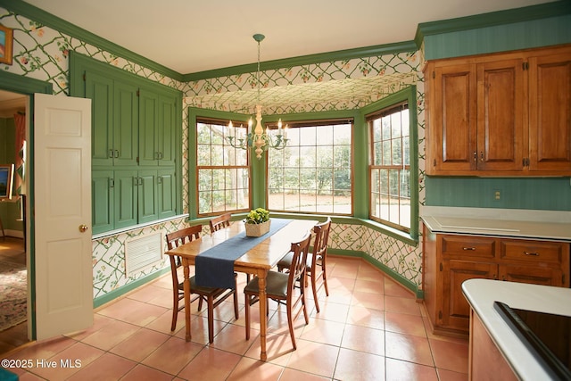 dining room with wallpapered walls, a notable chandelier, baseboards, and ornamental molding