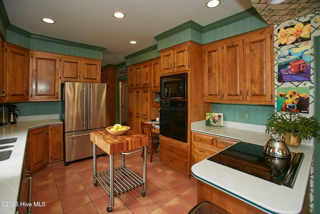 kitchen with oven, built in microwave, light countertops, light tile patterned floors, and high end fridge