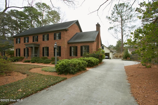 view of front of house featuring brick siding and a chimney