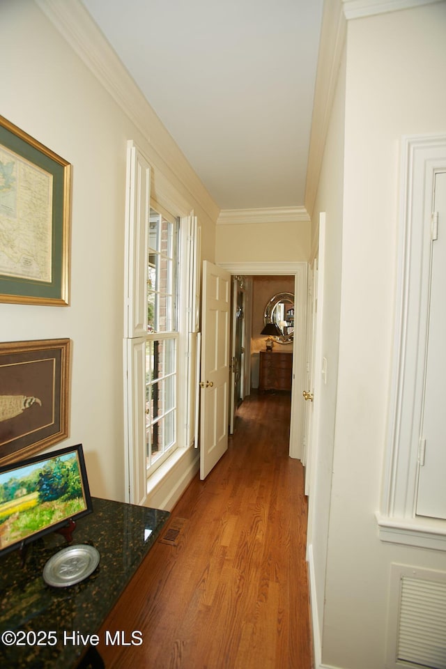 hall featuring crown molding, wood finished floors, and visible vents