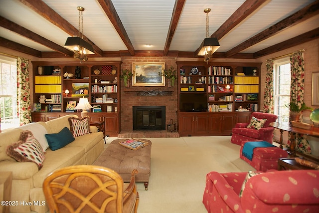 living room featuring beamed ceiling, carpet flooring, a fireplace, and an inviting chandelier