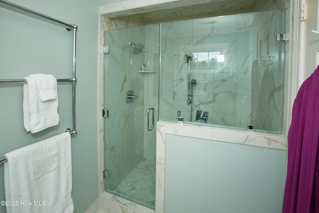 bathroom with marble finish floor and a marble finish shower