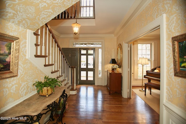 entrance foyer featuring stairway, wood finished floors, crown molding, and wallpapered walls