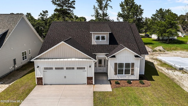 2366 Great Laurel Ct, Greenville, NC 27834 - view of front facade with board and batten siding, roof with shingles, an attached garage, driveway, and a front yard