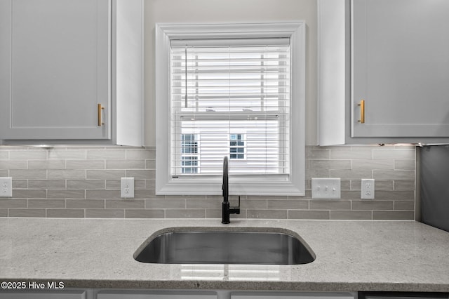 2366 Great Laurel Ct, Greenville, NC 27834 - kitchen with a sink, backsplash, and light stone countertops