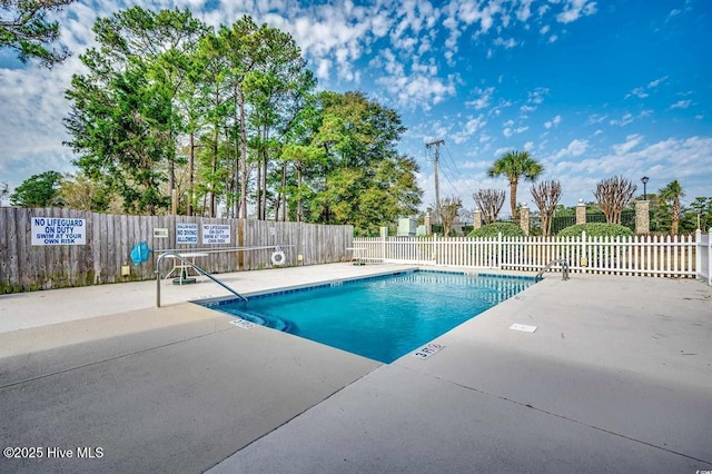 pool featuring a patio area and fence