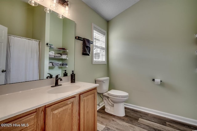 full bathroom with toilet, lofted ceiling, wood finished floors, baseboards, and vanity