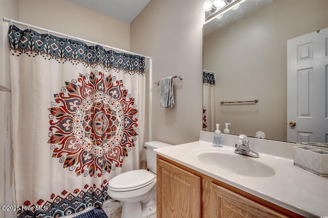 full bath with vanity, a shower with shower curtain, and toilet