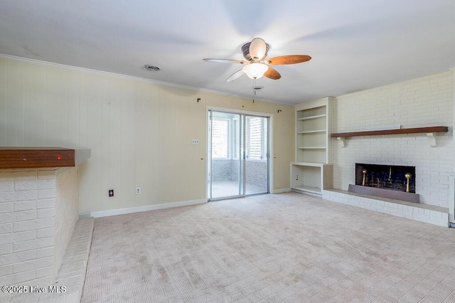 5218 Springwood Dr, Trent Woods, NC 28562 - unfurnished living room with a ceiling fan, visible vents, built in features, a brick fireplace, and carpet floors