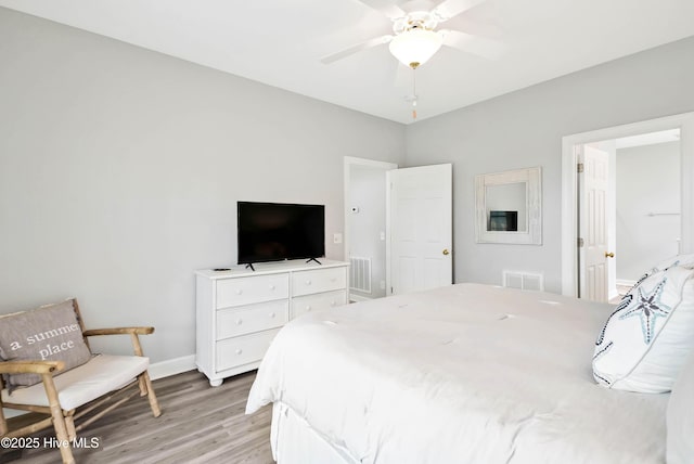 bedroom with visible vents, baseboards, light wood-style floors, and a ceiling fan