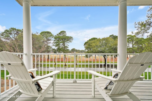 wooden terrace with a yard