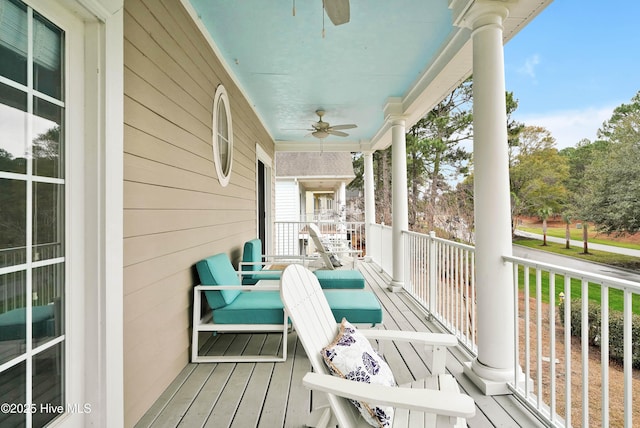 wooden deck featuring a porch and a ceiling fan