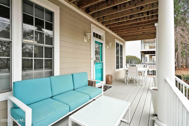 wooden deck featuring outdoor dining area and an outdoor hangout area