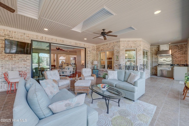 2184 Villamar Dr, Leland, NC 28451 - living area featuring a skylight, light tile patterned flooring, wood ceiling, and brick wall