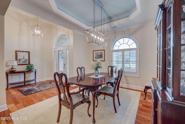 2184 Villamar Dr, Leland, NC 28451 - dining room featuring an inviting chandelier, a raised ceiling, crown molding, and wood finished floors
