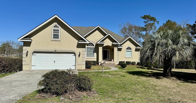 view of front of property with concrete driveway, a garage, a front yard, and stucco siding