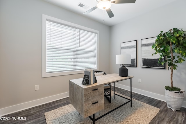 office space featuring visible vents, ceiling fan, baseboards, and dark wood-style flooring