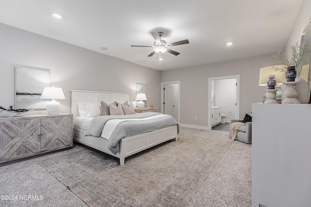 carpeted bedroom with baseboards, recessed lighting, ensuite bath, and a ceiling fan