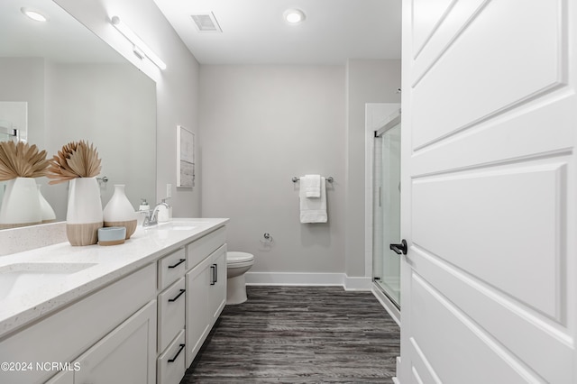 bathroom with a sink, visible vents, toilet, and a shower stall