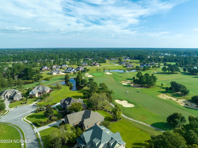 birds eye view of property featuring view of golf course, a water view, and a residential view