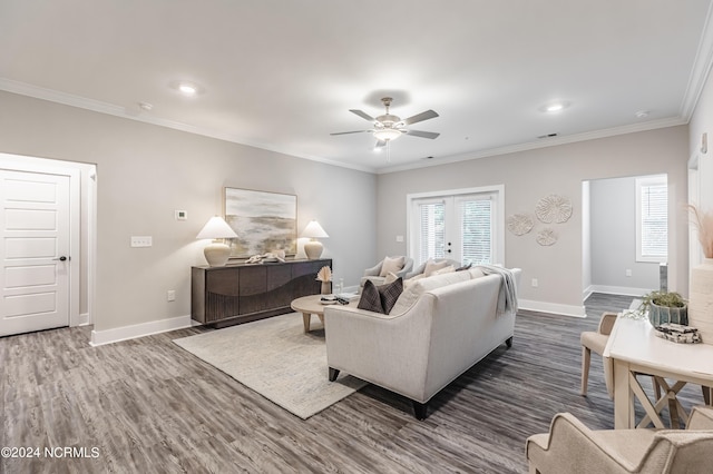 living area with visible vents, baseboards, dark wood-style flooring, ceiling fan, and ornamental molding