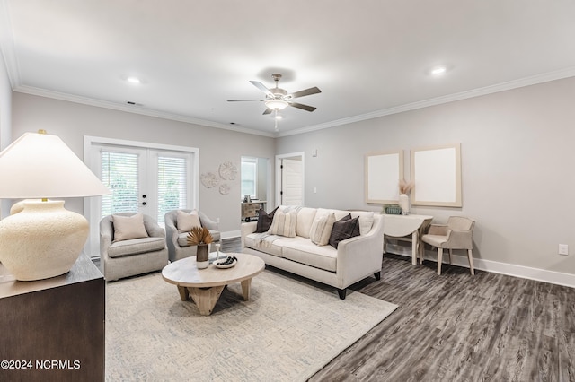 living room with wood finished floors, baseboards, and ornamental molding