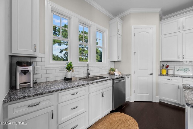 kitchen featuring stainless steel dishwasher, white cabinets, ornamental molding, and a sink