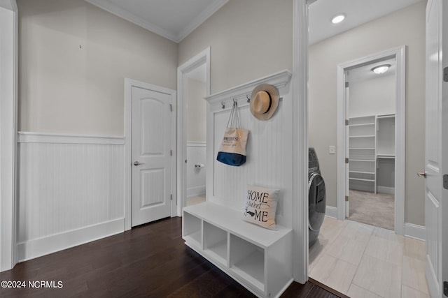 mudroom featuring washer / dryer, wood finished floors, wainscoting, and crown molding