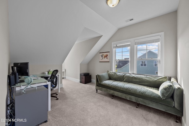 carpeted office space with vaulted ceiling, visible vents, and baseboards