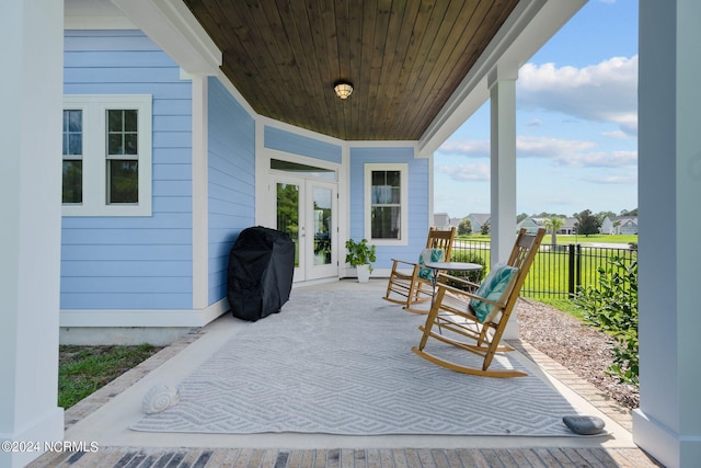 view of patio featuring area for grilling, french doors, and fence