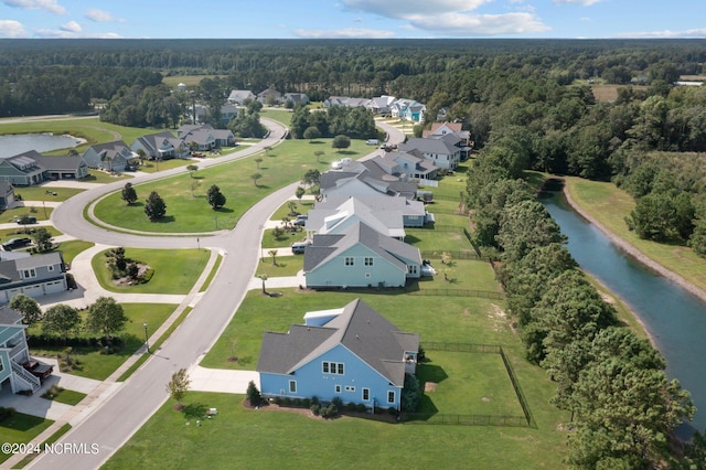 bird's eye view featuring a view of trees and a water view