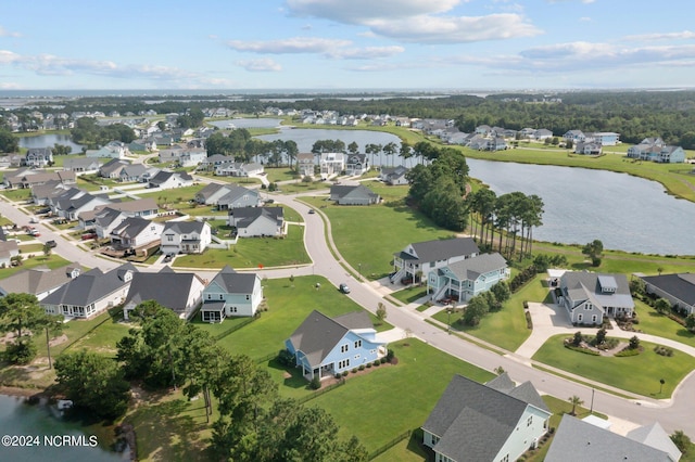 birds eye view of property with a water view and a residential view