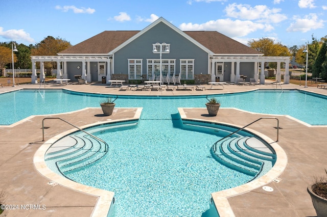 pool featuring a patio and a pergola