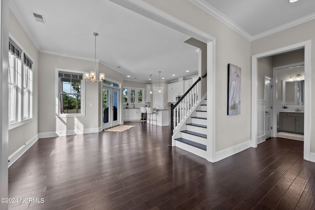 entrance foyer featuring visible vents, a healthy amount of sunlight, stairs, and wood finished floors