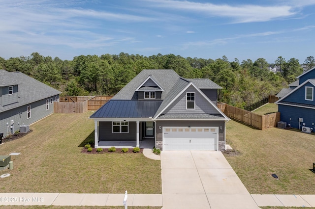 7053 Trailhead Rd, Leland, NC 28451 - view of front of house with a porch, driveway, stone siding, metal roof, and central AC
