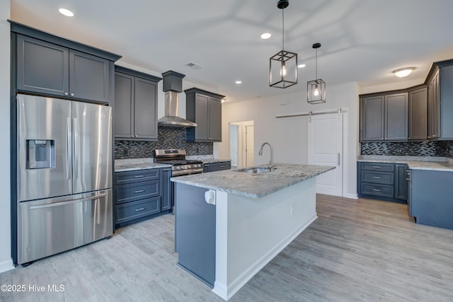 7053 Trailhead Rd, Leland, NC 28451 - kitchen with appliances with stainless steel finishes, wall chimney exhaust hood, a sink, tasteful backsplash, and light wood-style floors