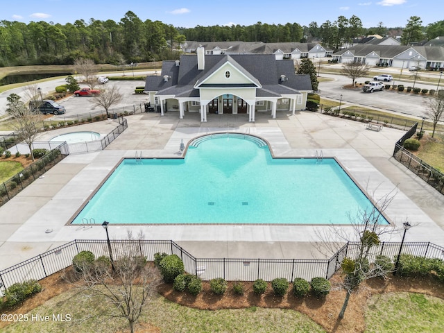 7053 Trailhead Rd, Leland, NC 28451 - community pool with fence, a patio, and a community hot tub