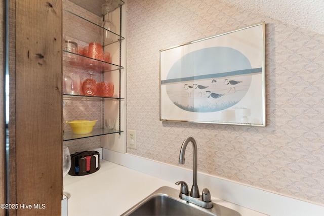 interior space featuring a sink and wallpapered walls